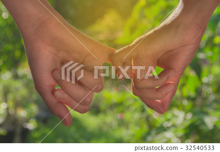 little finger of lady and younger lady holding little finger of lady and younger lady holding 32540533