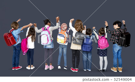 Rear view group of diverse kids standing in a row holdings hands in the air 32549004
