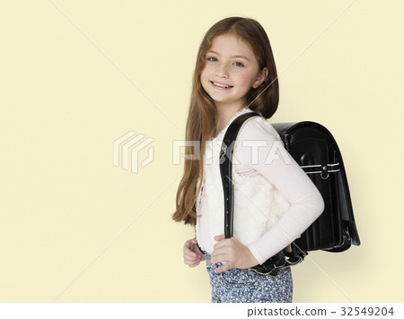 Young freckled girl carrying a backpack smiling portrait Young freckled girl carrying a backpack smiling portrait 32549204