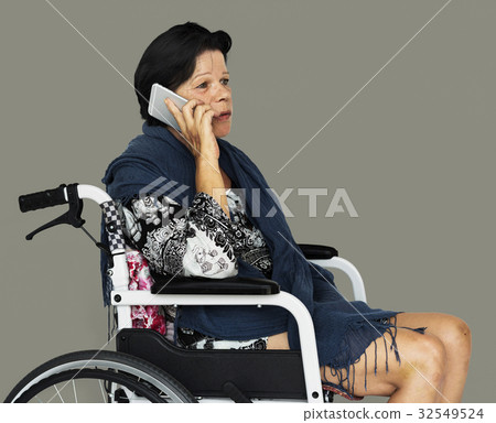 Senior adult woman on wheelchair talking on the phone Senior adult woman on wheelchair talking on the phone 32549524