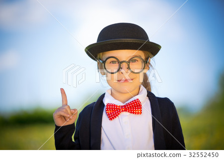 Funny little girl in glasses, bow tie and bowler 32552450