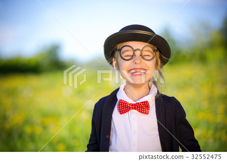 Funny happy little girl in bow tie and bowler hat. Funny happy little girl in bow tie and bowler hat. 32552475