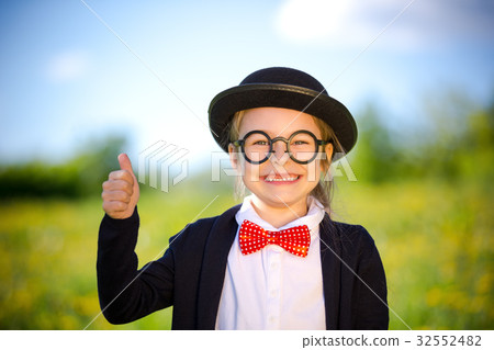 Funny little girl in bow tie and bowler hat 32552482