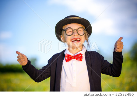 Funny little girl in bow tie and bowler hat 32552490