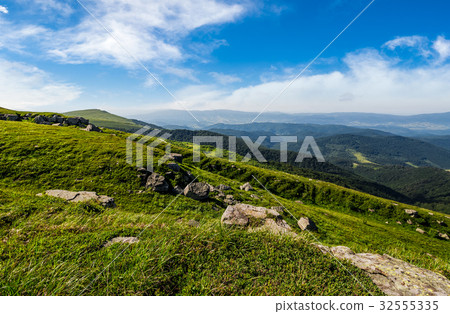 blue cloudy sky over mountains with rocky hillside blue cloudy sky over mountains with rocky hillside 32555335