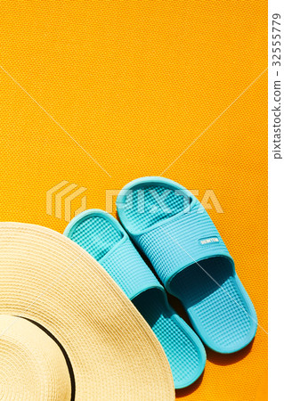 Beautiful straw hat with blue flip flops  32555779