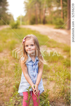 Happy girl in a summer park 32556239