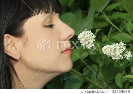 Young Woman Enjoying Smelling aroma Flowers 32558659