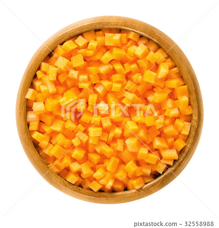 Carrot cubes in wooden bowl over white 32558988