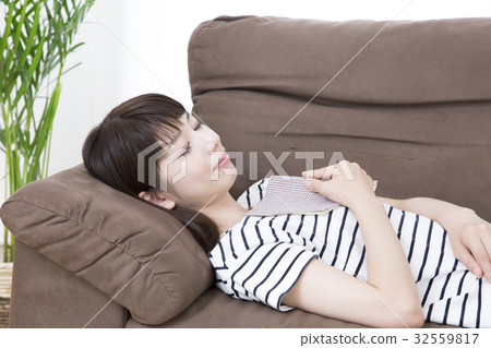 A young woman taking a nap on the sofa A young woman taking a nap on the sofa 32559817