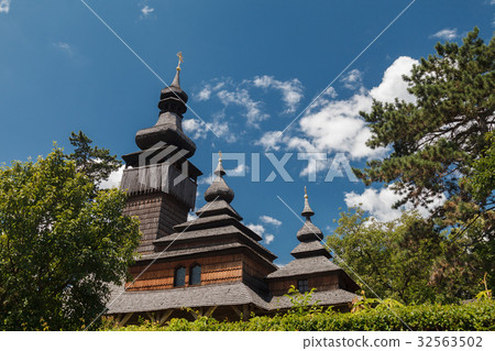 Old wooden Lemk church against a bright blue sky Old wooden Lemk church against a bright blue sky 32563502