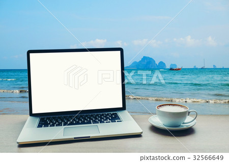 Laptop computer with blank white screen on table 32566649