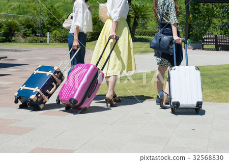 A woman pulling a girls traveling carry bag A woman pulling a girls traveling carry bag 32568830