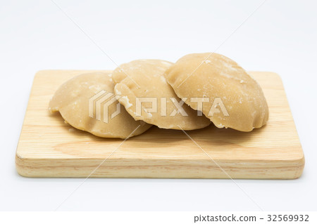 Palm sugar hard condition on wooden board Palm sugar hard condition on wooden board 32569932