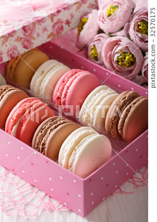Festive macaroons in a gift box and flowers 32570175