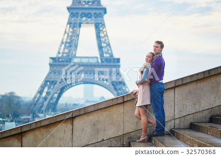 Couple near the Eiffel tower in Paris Couple near the Eiffel tower in Paris 32570368