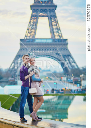 Couple near the Eiffel tower in Paris Couple near the Eiffel tower in Paris 32570376
