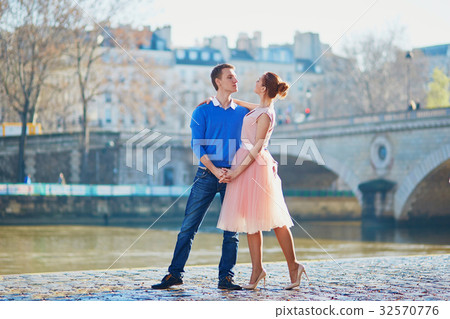 Romantic couple on the Seine embankment in Paris Romantic couple on the Seine embankment in Paris 32570776