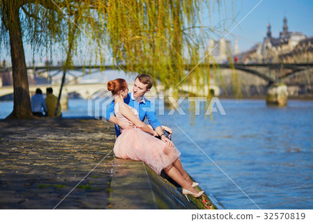 Romantic couple on the Seine embankment in Paris Romantic couple on the Seine embankment in Paris 32570819