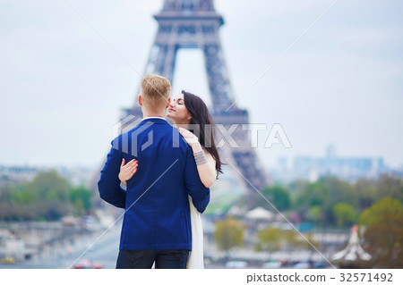 Romantic couple in Paris near the Eiffel tower Romantic couple in Paris near the Eiffel tower 32571492