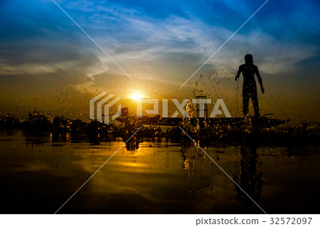 silhouette fisherman with sunset sky on the lake. silhouette fisherman with sunset sky on the lake. 32572097