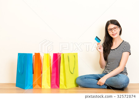 mixed race female model sitting on wooden floor mixed race female model sitting on wooden floor 32572874
