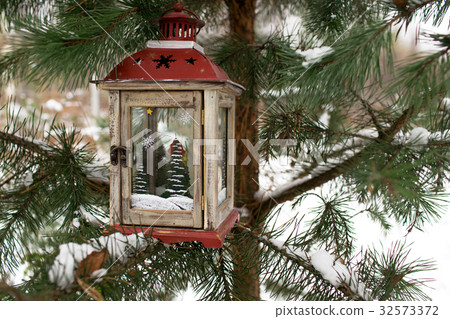 Christmas lantern on a Christmas tree 32573372