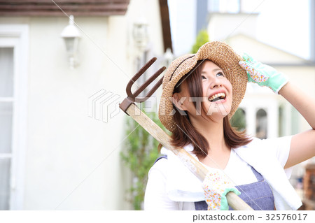 A woman enjoying a family garden A woman enjoying a family garden 32576017