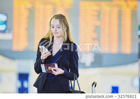 Young business woman in international airport Young business woman in international airport 32576821