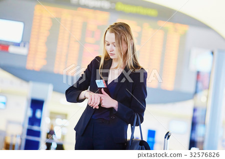 Young business woman in international airport Young business woman in international airport 32576826
