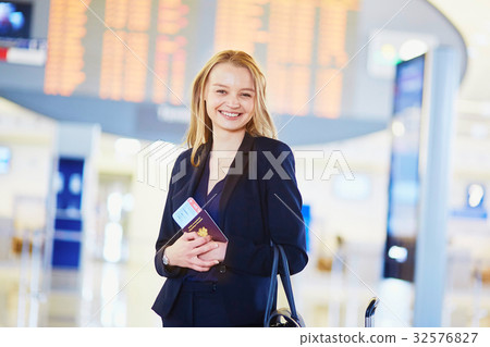 Young business woman in international airport Young business woman in international airport 32576827
