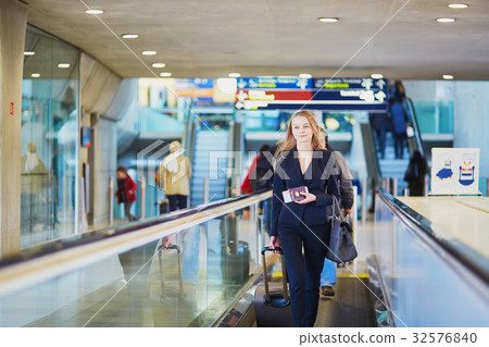 Business woman with hand luggage in international airport 32576840