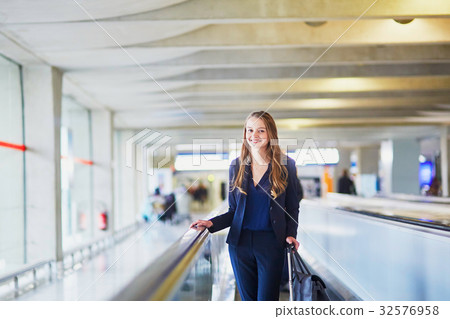 Woman on travelator in the international airport 32576958