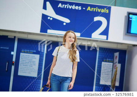 Beautiful young tourist girl with backpack and carry on luggage Beautiful young tourist girl with backpack and carry on luggage 32576981