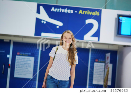 Beautiful young tourist girl with backpack and carry on luggage in international airport Beautiful young tourist girl with backpack and carry on luggage in international airport 32576983