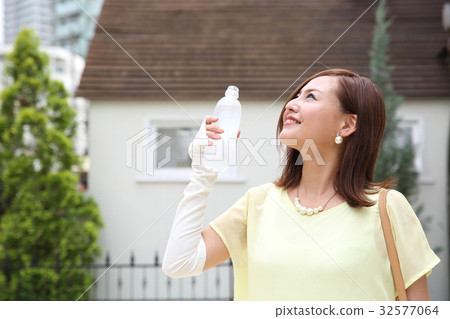 A woman drinking water A woman drinking water 32577064