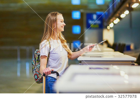 Traveler with backpack in international airport at check-in counter 32577078