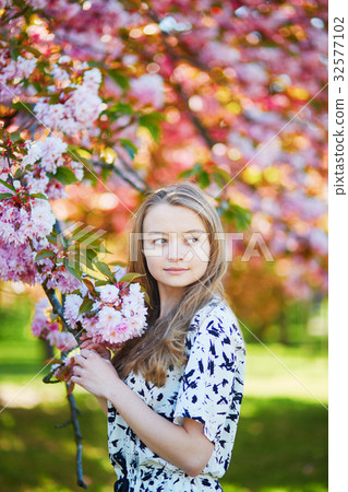 Beautiful young woman in blooming spring park Beautiful young woman in blooming spring park 32577102