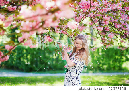 Beautiful young woman in blooming spring park Beautiful young woman in blooming spring park 32577136