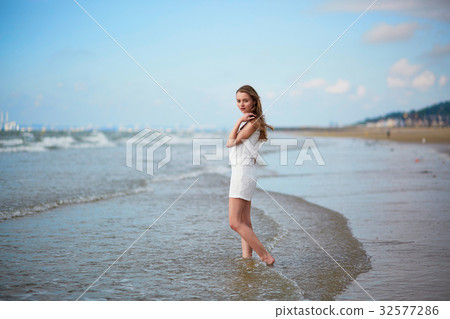 Beautiful young woman enjoying her vacation by ocean or sea 32577286