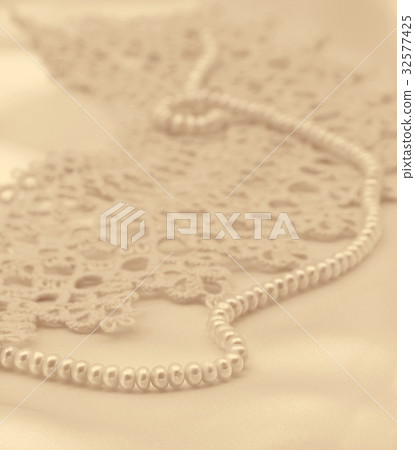 Smooth elegant golden silk or satin with pearls Smooth elegant golden silk or satin with pearls 32577425