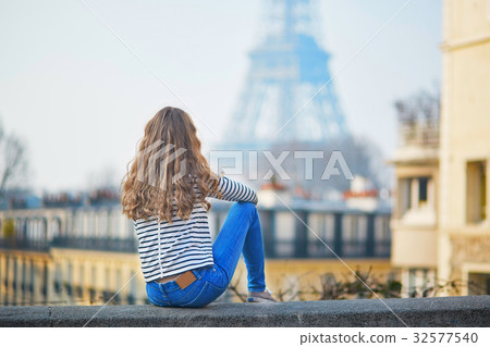 Girl outdoors near the Eiffel tower, in Paris Girl outdoors near the Eiffel tower, in Paris 32577540