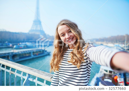 Young girl taking selfie near the Eiffel tower 32577660