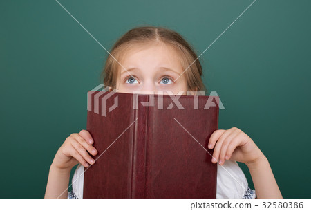 Pupil posing at school board, education concept  32580386