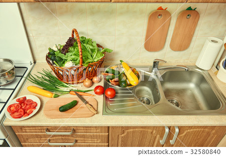 vegetables and greens food in kitchen interior vegetables and greens food in kitchen interior 32580840