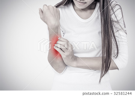 Woman scratching her elbow. Woman scratching her elbow. 32581244