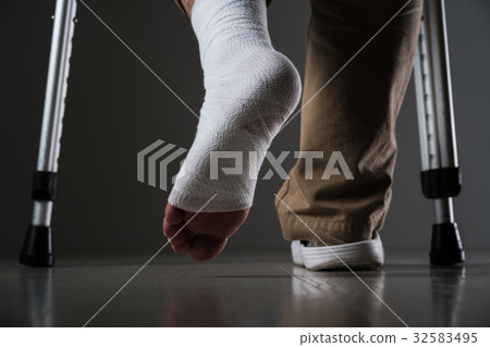 A man injured his leg, a crutch 32583495