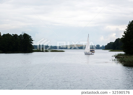 Lonely sailing boat at the lake near Trakai castle 32590576