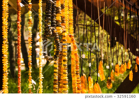 Amber pendants and necklaces at the street 32591160