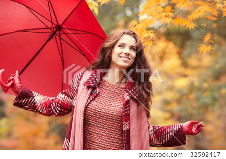 season and people concept - beautiful happy young woman walking 32592417